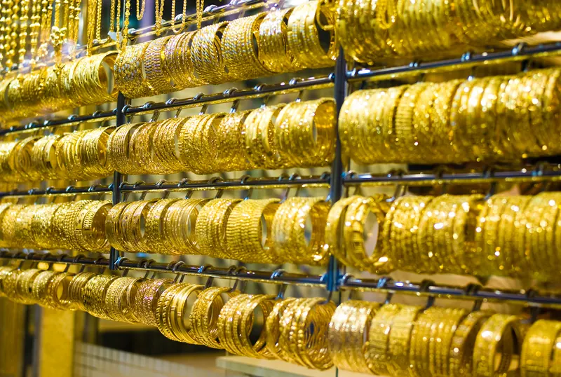 Rows of gold bangles in a Gold Souk shop window